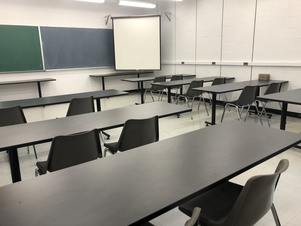 classroom with projection screen in the back